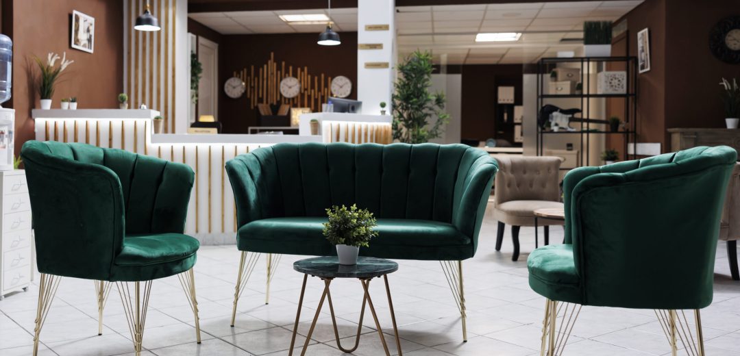 Luxury lounge area in hotel reception with modern decorations and marble floors used to welcome guests. Spacious resort lobby with expensive accommodation, check in registration desk.